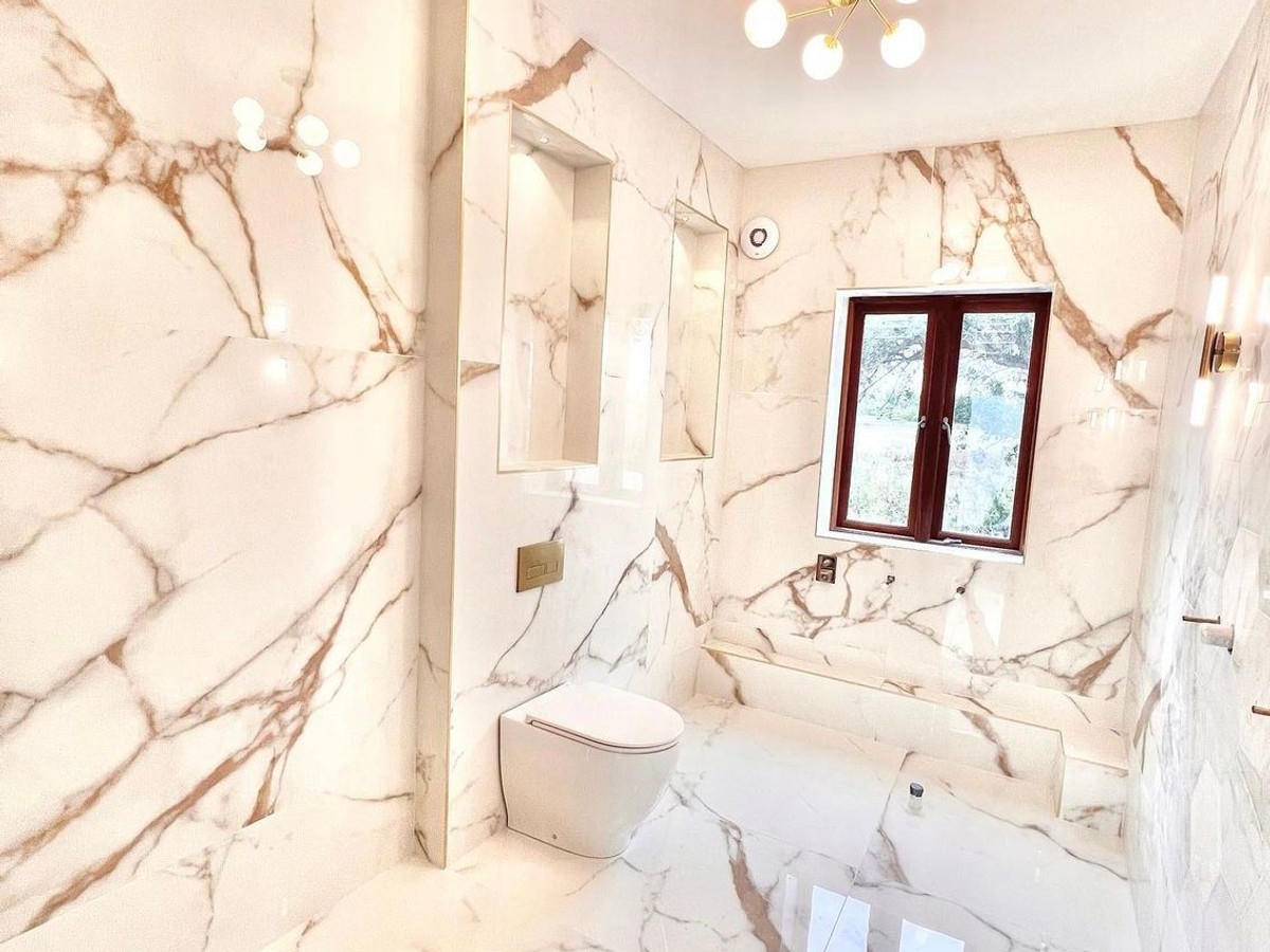 Bathroom lighting with globe pendant and wall-mounted fixtures