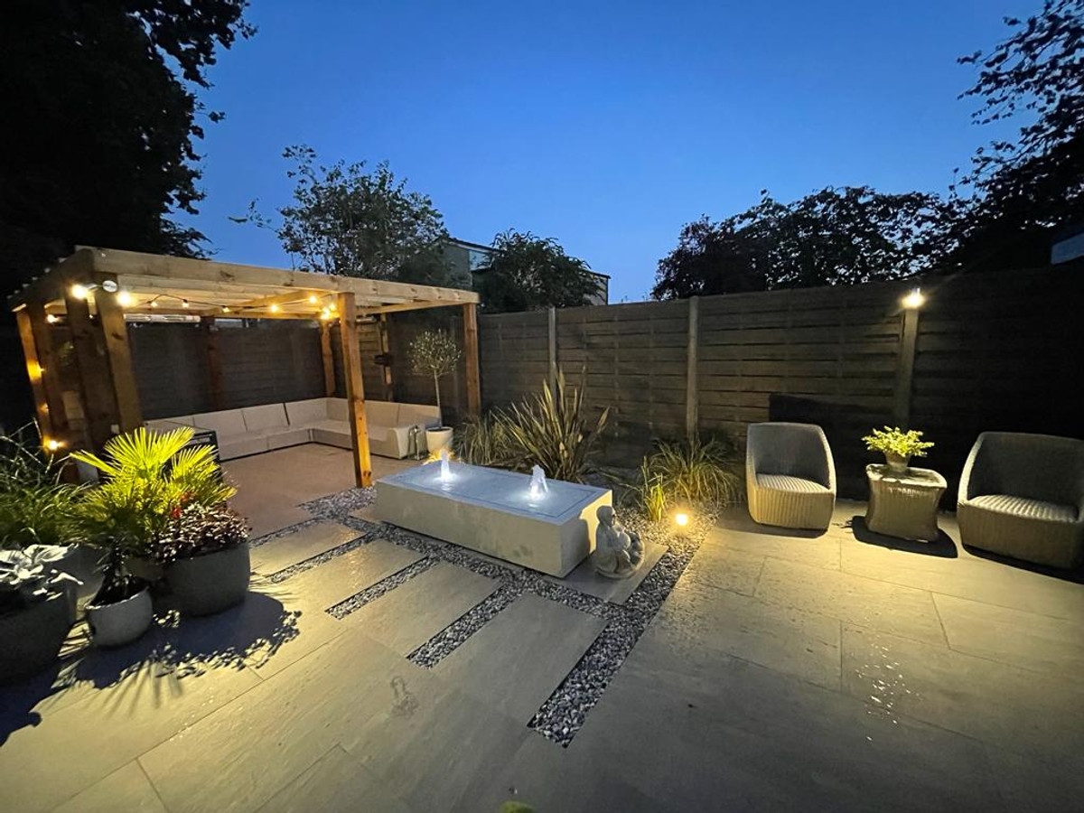 Garden lighting with illuminated patio and seating area at dusk