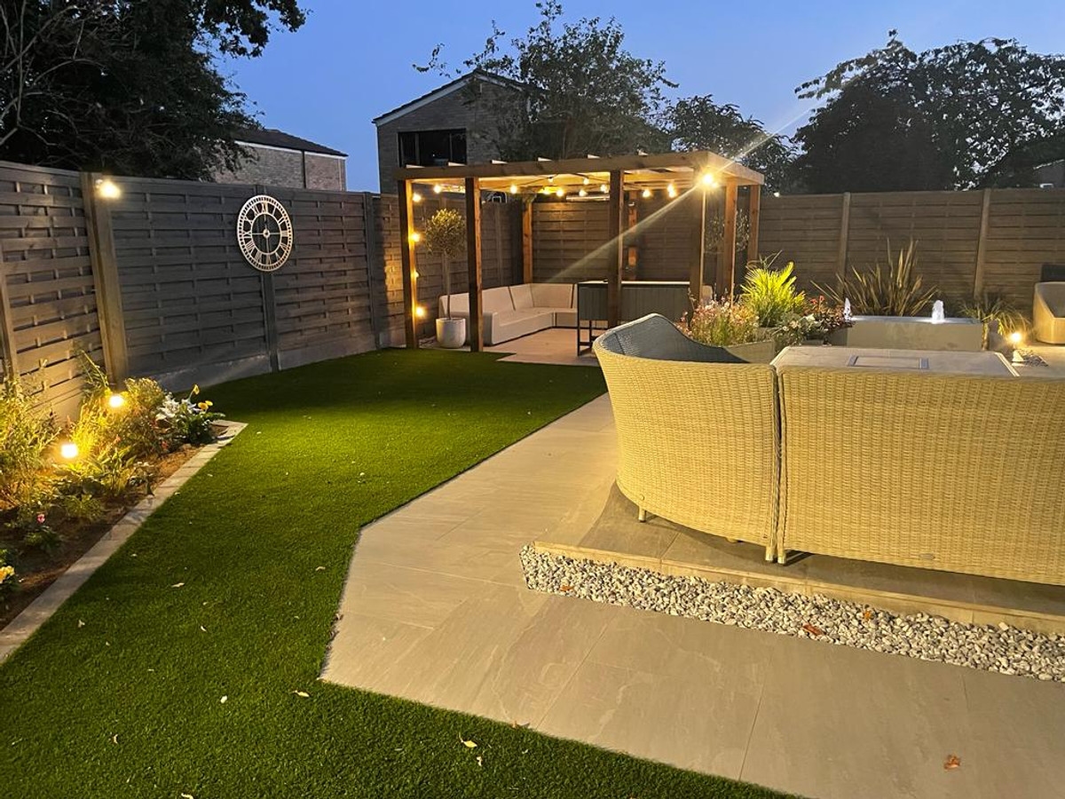 Garden with festoon lighting, lawn lights, and pergola