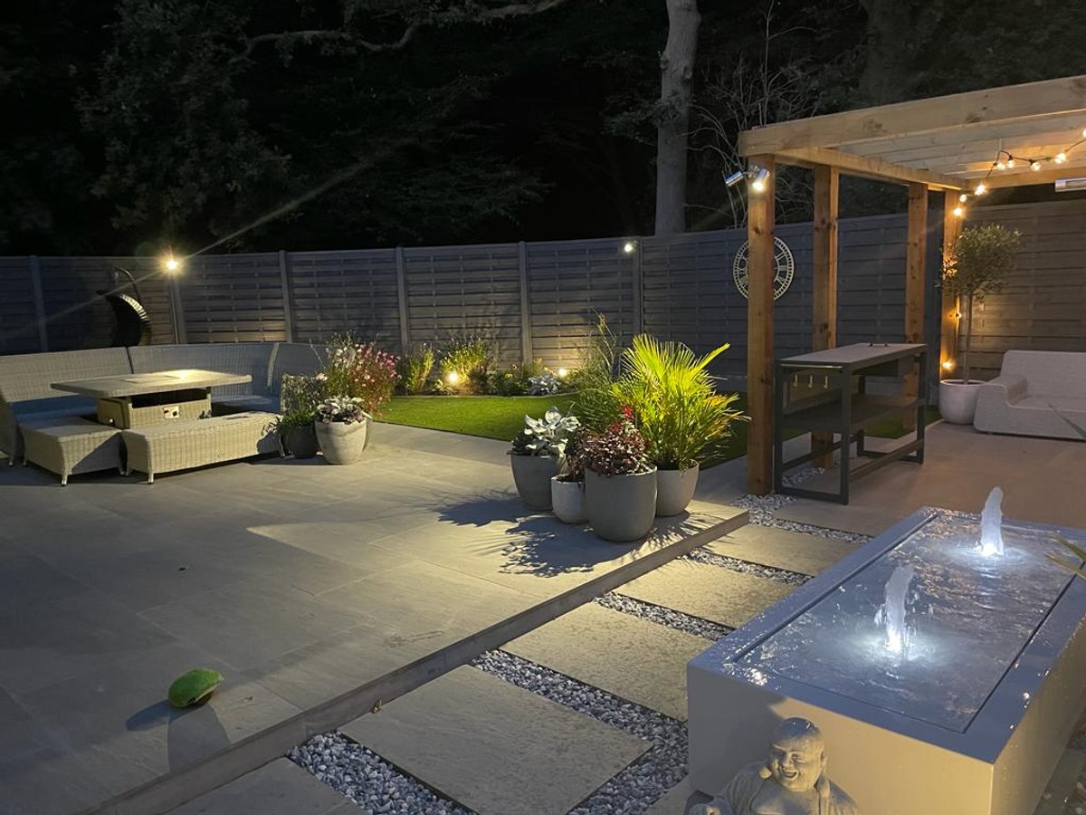 Landscaped garden with water feature and outdoor lighting